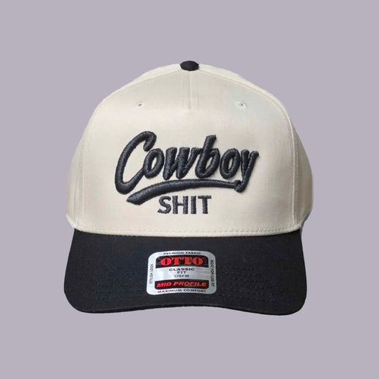 Cowboy Shit Embroidered Hat — Cream & Black — product view on grey-purple background