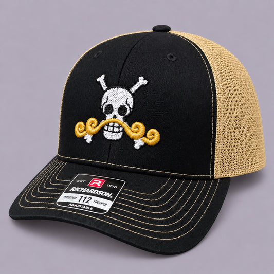 Left angled view of black and Vegas gold Richardson 112 embroidered pirate skull trucker hat