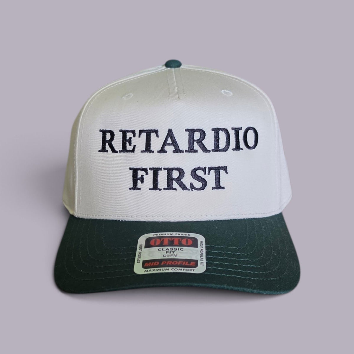 Retardio First white and green embroidered hat on lavender-grey background