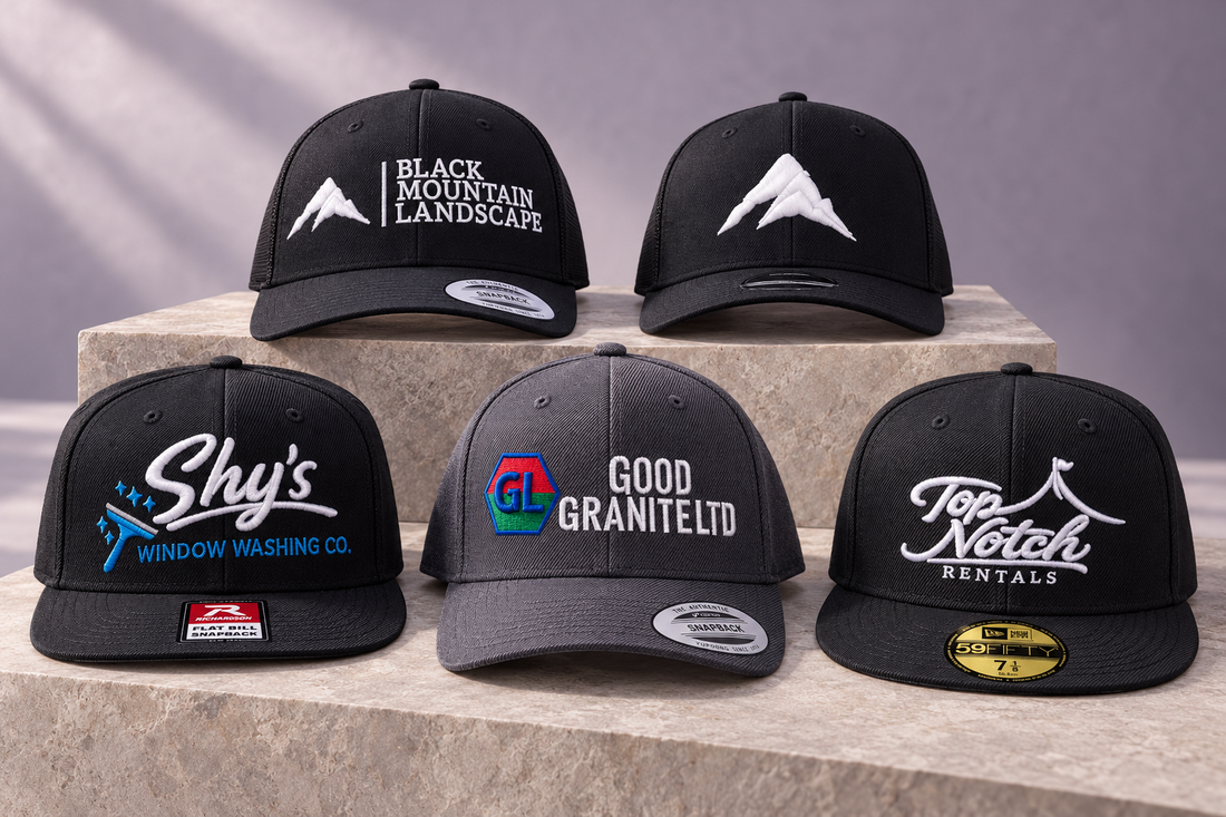 Five custom embroidered business hats by Stitchop, featuring Black Mountain Landscape, Shy’s Window Washing Co., Good Granite Ltd and Top Notch Rentals.