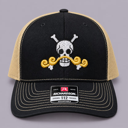Front of black and Vegas gold Richardson 112 hat with white pirate skull and gold moustache embroidery