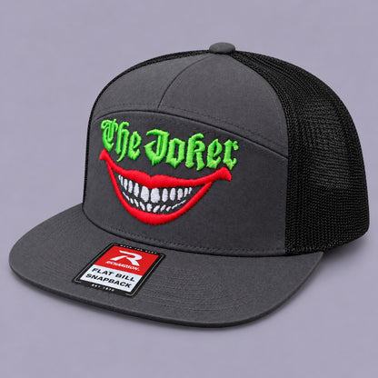 The Joker charcoal Richardson mesh snapback with green lettering and red grin embroidery, angled view