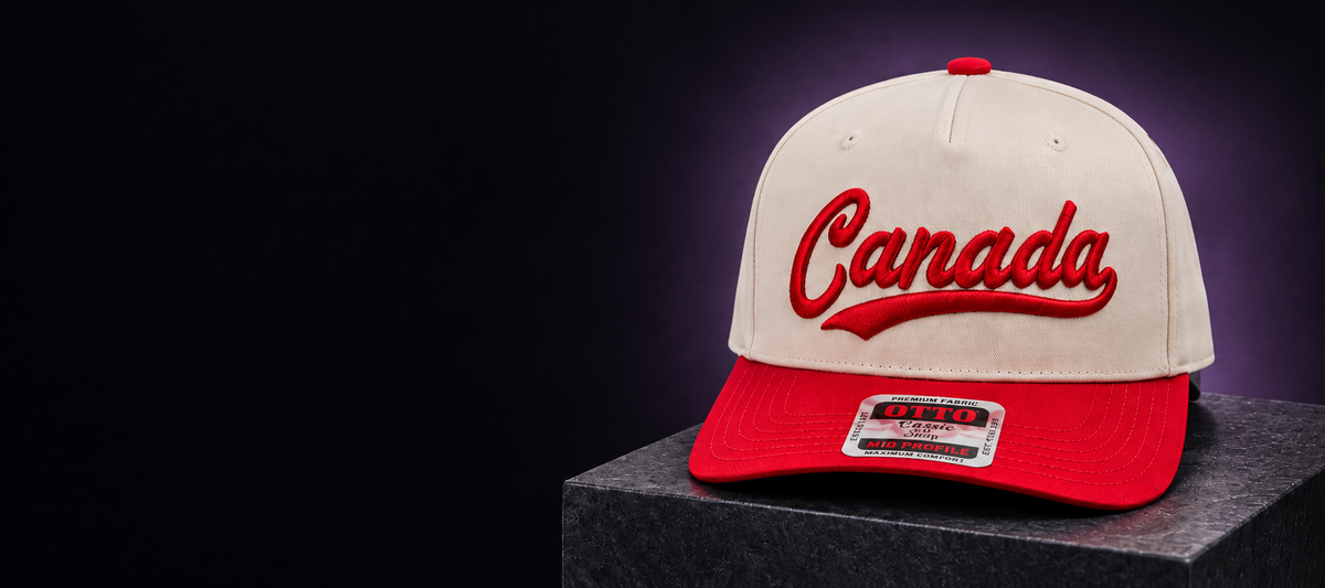 Cream and red Canada embroidered snapback on a dark stone pedestal