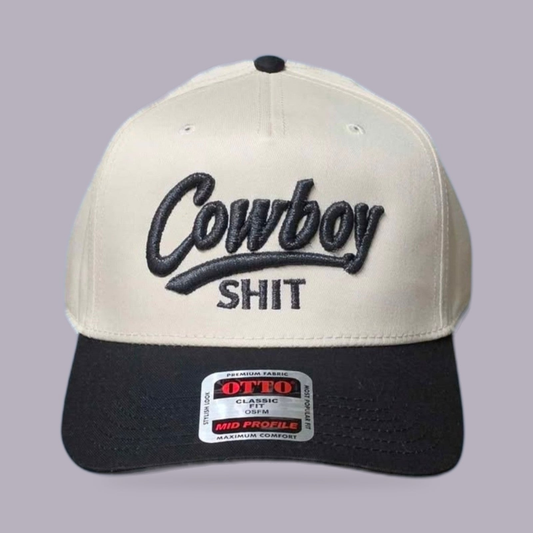 Cowboy Shit Embroidered Hat — Cream & Black — product view on grey-purple background