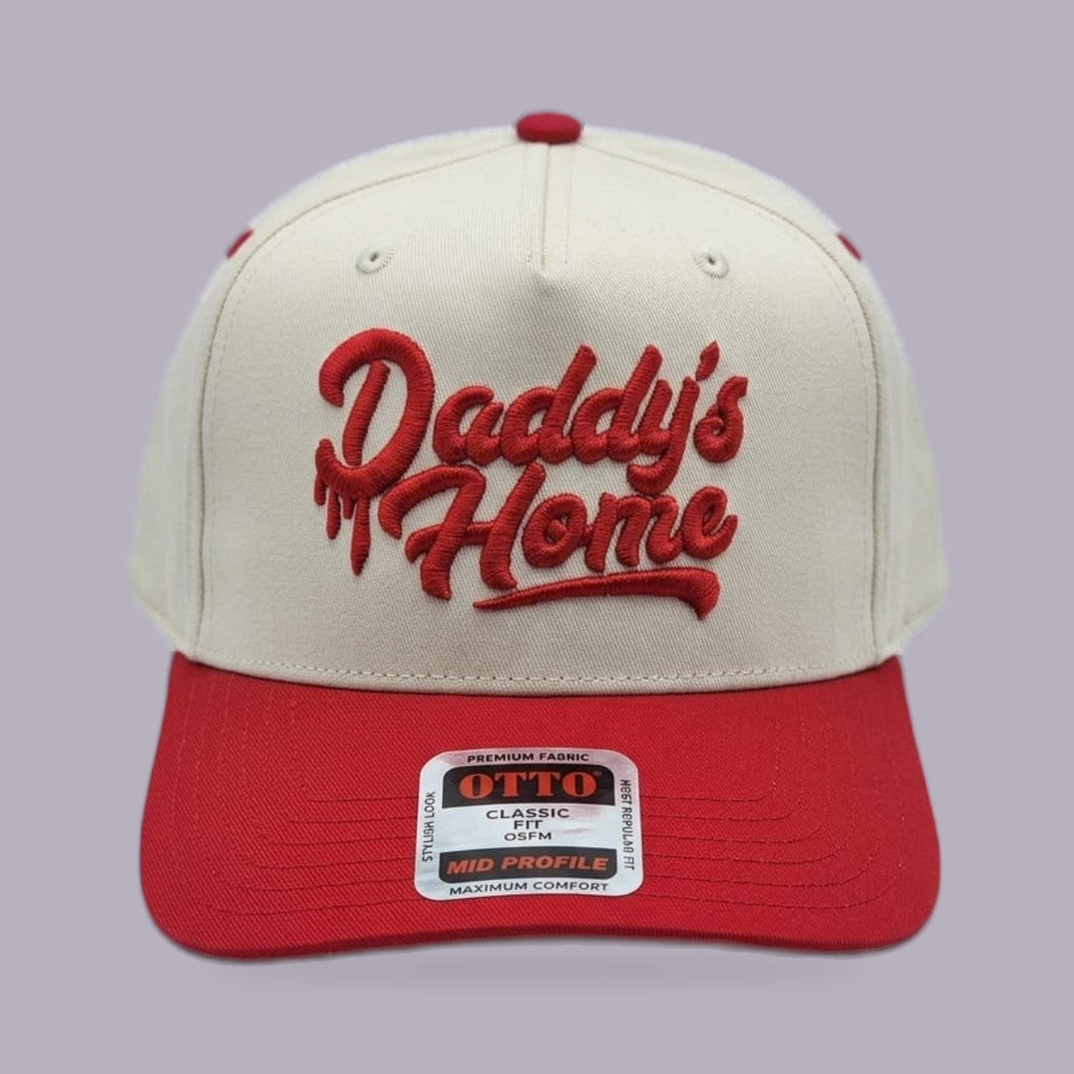 Daddy’s Home Embroidered Hat — Cream & Red — product view on grey-purple background