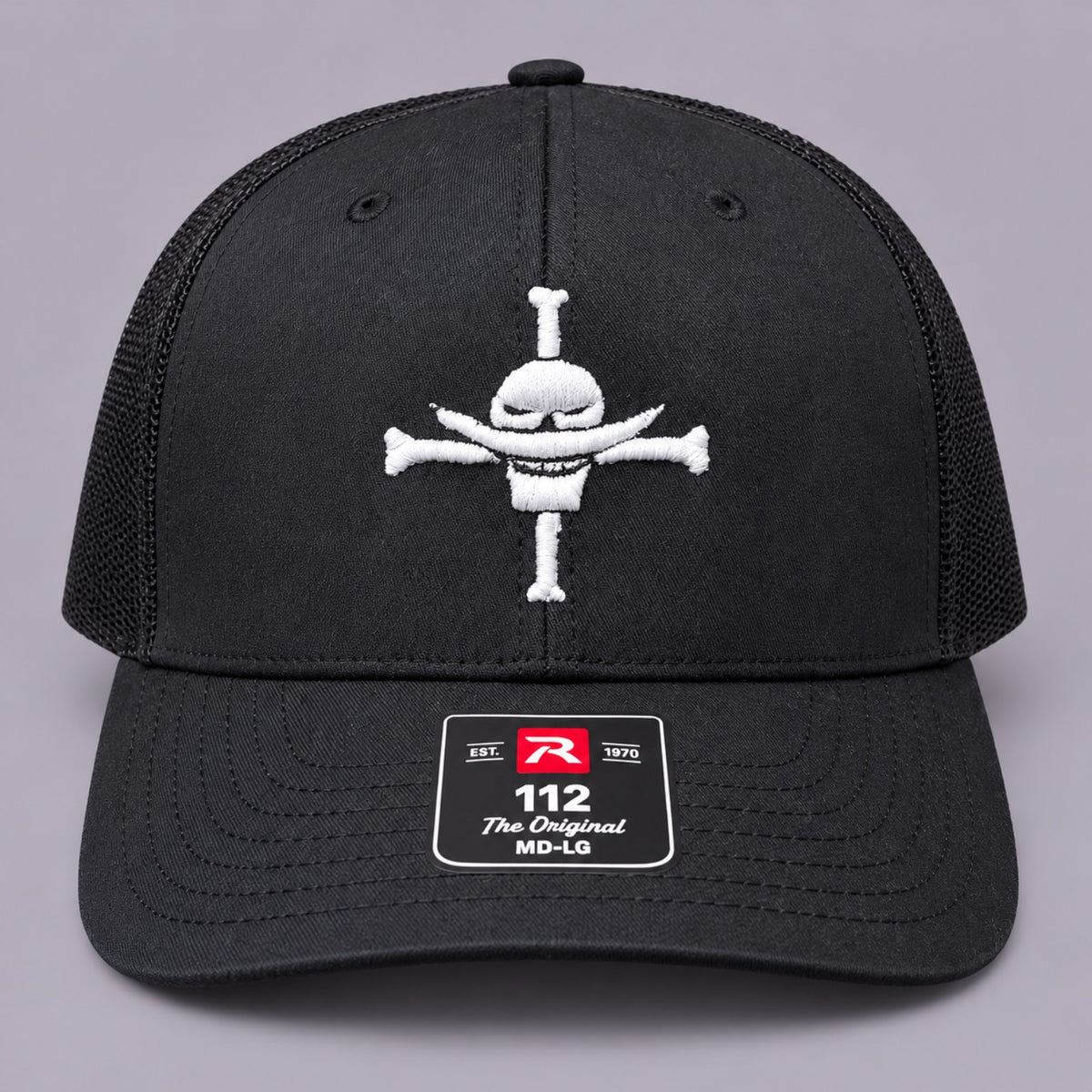 Front view of black Richardson 112 trucker hat with white Whitebeard Pirates embroidery