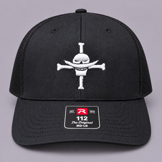 Front view of black Richardson 112 trucker hat with white Whitebeard Pirates embroidery