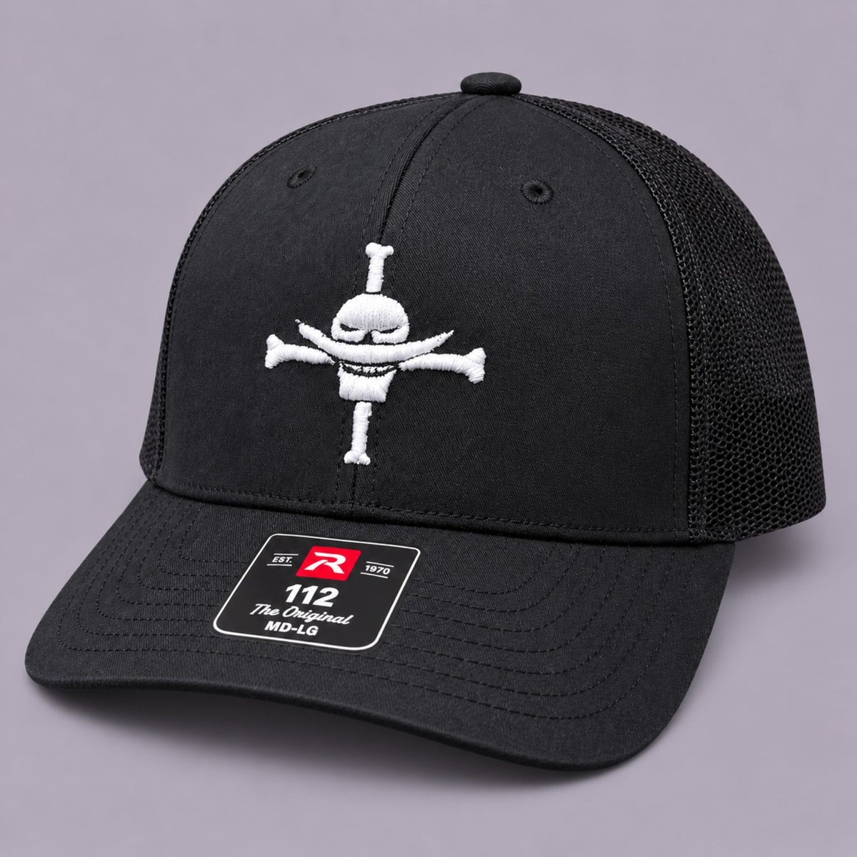 Angled view of black Richardson 112 Whitebeard Pirates embroidered hat with black mesh back