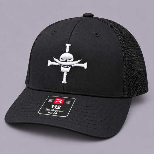 Angled view of black Richardson 112 Whitebeard Pirates embroidered hat with black mesh back